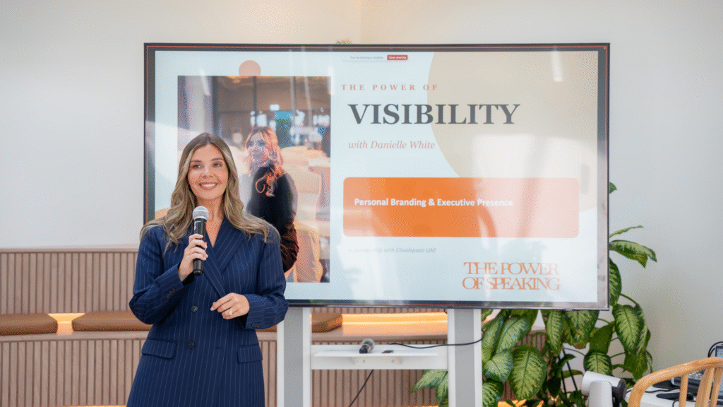 Danielle White speaking on stage during a visibility workshop