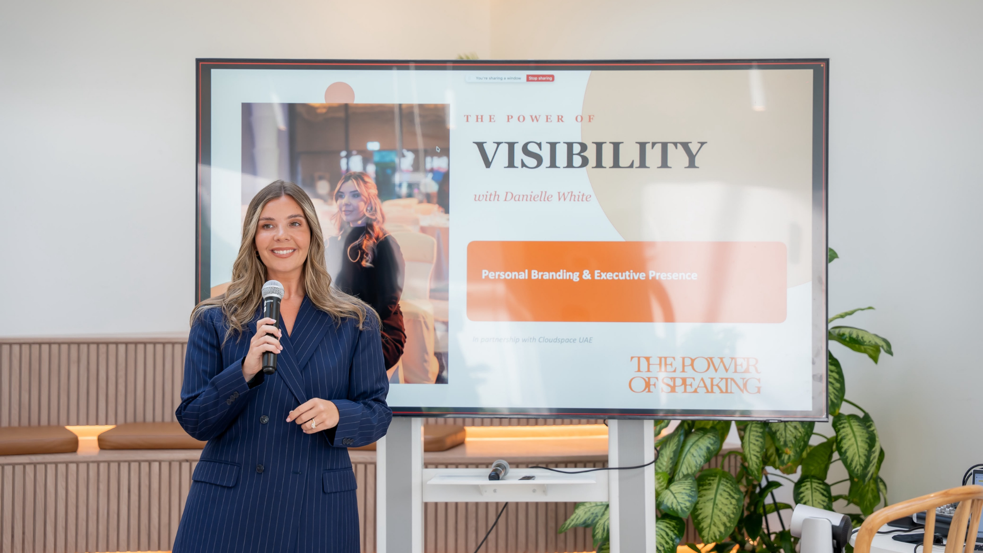 Danielle White speaking on stage during a visibility workshop